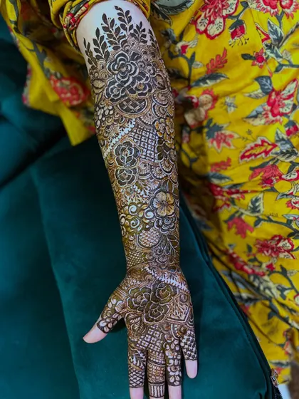 Another angle of the same full bridal floral design, highlighting the consistency and flow of the patterns around the arm.