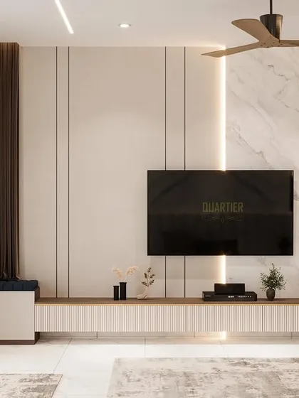 The TV unit in the contemporary master bedroom. The design uses a combination of marble, wood louvers, and clean white surfaces to create a sophisticated and modern entertainment wall.