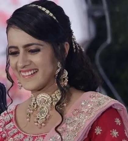 A close-up of the bride's reception look. The smile on her face shows how confident and beautiful she feels in her custom jewellery.