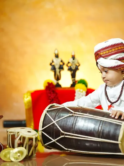 Our little musician tries his hand at the pakhawaj drum, a key instrument in the Varkari tradition.