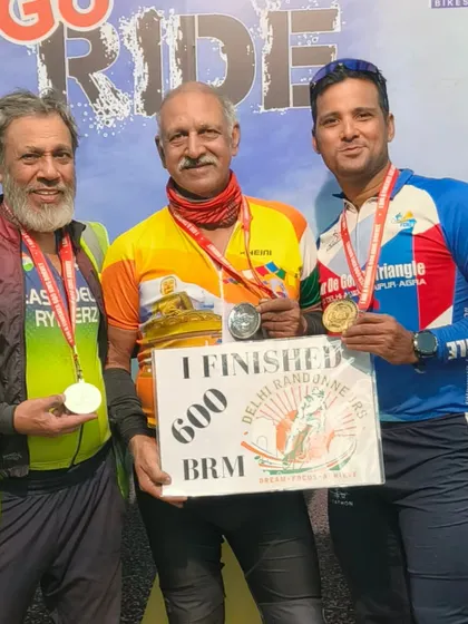 The three legends with their medals and finisher board. An iconic picture of endurance, age, and friendship.