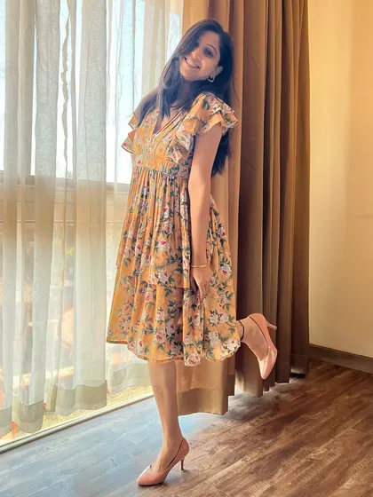 This mustard yellow tiered dress is a must-have for your wardrobe. The floral print and flutter sleeves add effortless charm.