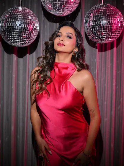 A full-length view of the model in the pink dress, capturing the vibrant and energetic mood of the shoot.