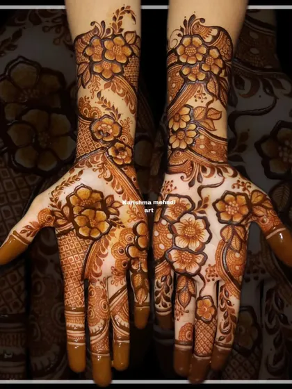 A classic floral mehendi with a mix of different flower sizes and styles. The design covers the hands completely, offering a rich and textured look perfect for a bride.