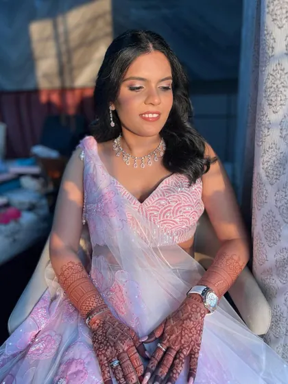 A beautiful sunset-hour shot of the bride. The warm light enhances her flushed, rosy makeup.