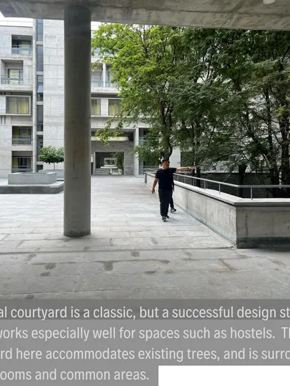 A view from within a colonnade looking into the central courtyard. These transitional spaces are porous and inviting, blurring the line between inside and outside.