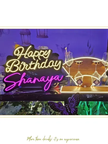 A custom "Happy Birthday Shanaya" neon sign at our bar. We love adding personalized touches to birthday celebrations.