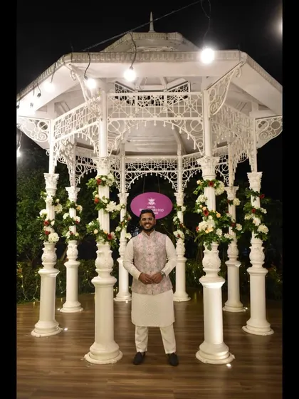 Posing in front of a beautiful white gazebo.