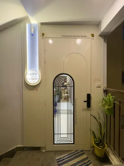 A glimpse of a 3BHK interior, starting with this elegant main door. The design features a classic look with a modern security grille and a stylish nameplate.