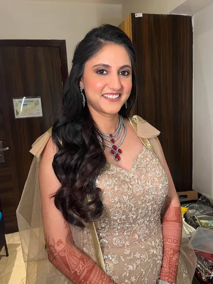 Full-on glam for this bride's Sangeet. We focused on super glowy skin, a beautiful lip color, and soft, sultry eyes. The big, bouncy hair adds to the luxe, party-ready vibe.
