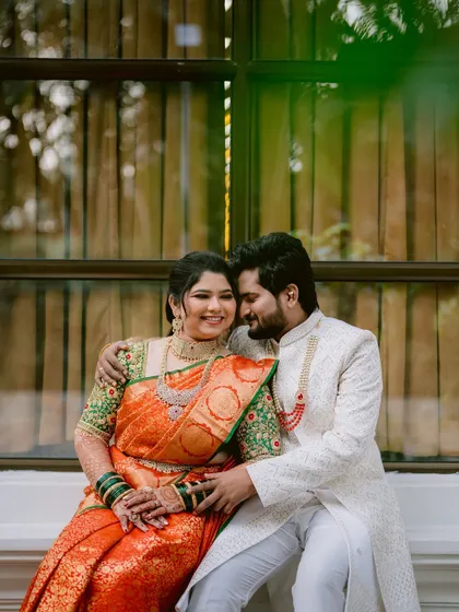 A comfortable and happy portrait of the couple seated together.