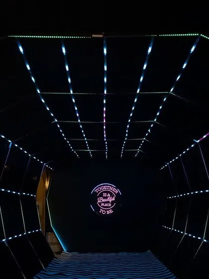 The entrance to the Sangeet was a futuristic tunnel of light, creating an exciting and dramatic transition into the main event space.