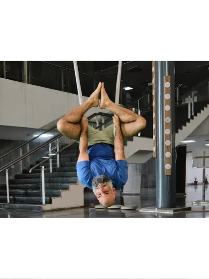 Our instructor demonstrates an advanced inverted binding pose, showing the level of body control and flexibility that can be achieved with consistent practice.