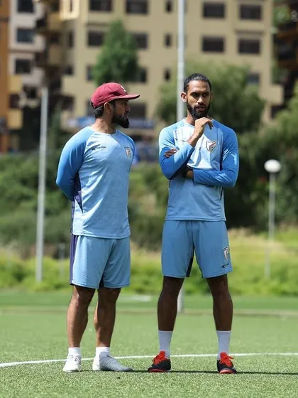 A quiet moment of discussion and strategy with a fellow coach on the training ground in Bhutan. Collaboration and planning are key to a successful camp.
