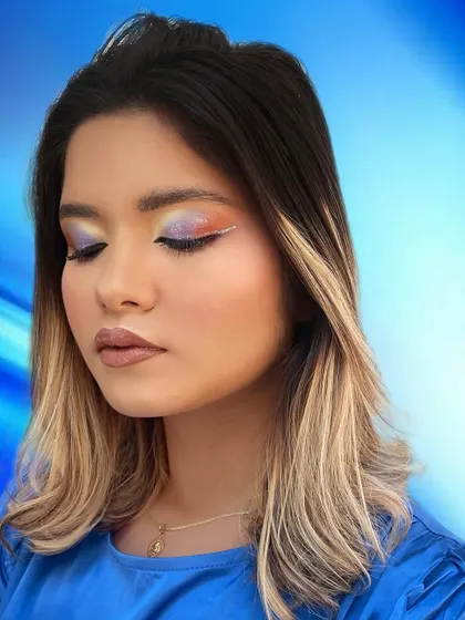 A soft glam look with a colorful twist. The subtle rainbow blending on the eyelid adds a unique touch to this otherwise neutral and wearable style.