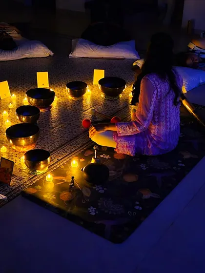 A view from a group sound bath, where everyone finds their own comfortable space. The collective energy in the room, combined with the candlelit ambiance, enhances the deeply calming experience for all.
