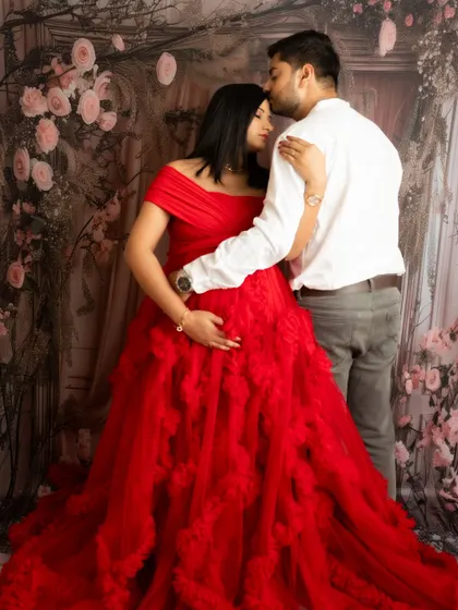 An intimate embrace against a floral backdrop. This pose is perfect for capturing the romance and love between the couple.