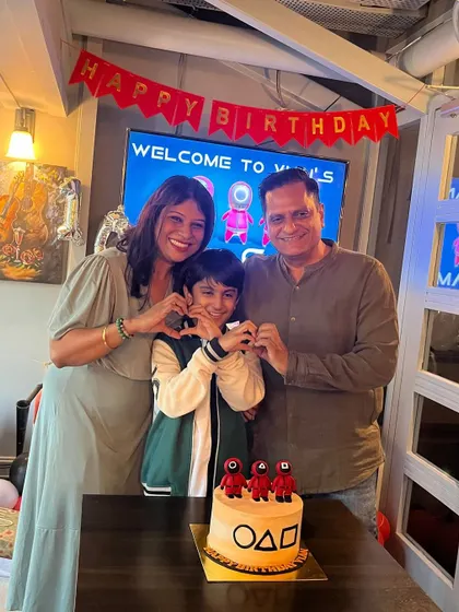 A beautiful family photo with the birthday boy and his incredible themed cake. We love making these moments happen.