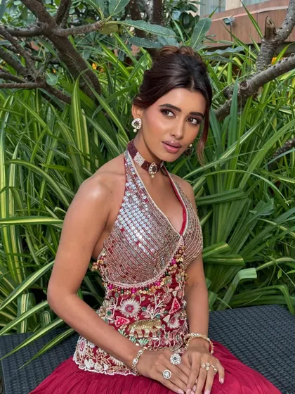 This angle showcases the beautiful halter-neck top and the complementary choker, with makeup that enhances the overall look.