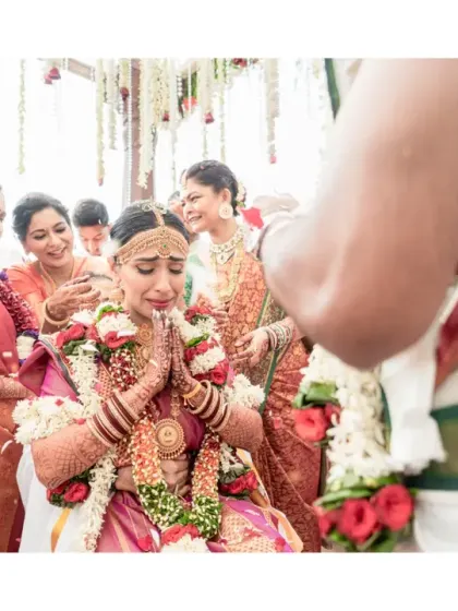 Overwhelmed with emotion, the bride prays during a key moment of her South Indian wedding ceremony. This powerful image captures the spiritual and emotional depth of the rituals.
