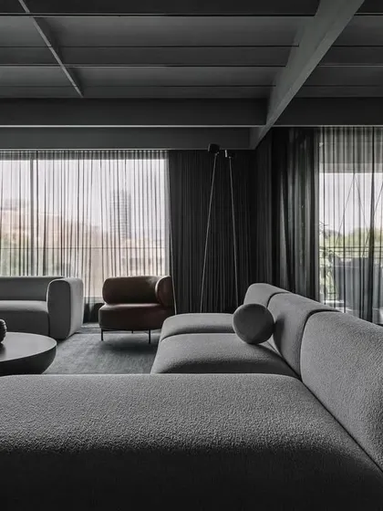 A close-up of the living area, detailing the texture of the sofa fabric and the clean lines of the surrounding architecture.