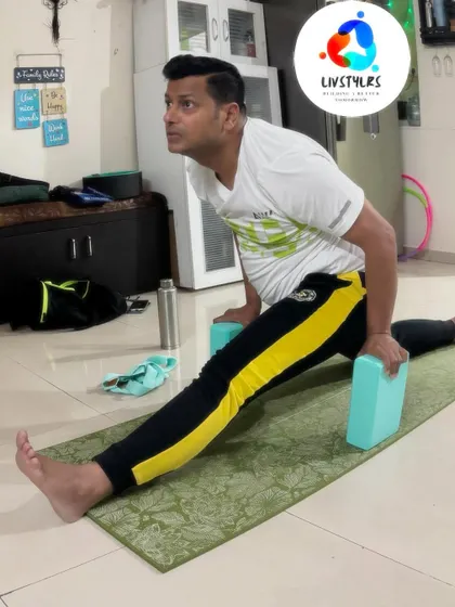 I am demonstrating Hanumanasana, the full splits, using blocks for support. This shows how props can be used to work towards advanced poses safely and progressively.