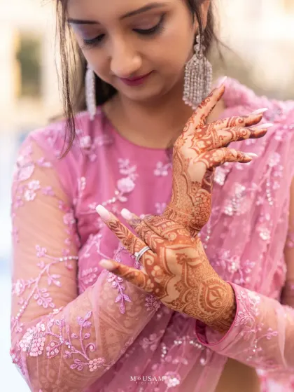 The intricate art of Mehendi tells a story on the bride's hands. I love focusing on these details, where the delicate patterns and the bride's graceful pose come together to create a timeless and elegant portrait.