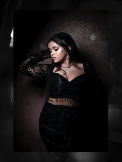 In this shot, we used shadows to create a sense of mystery and elegance. The model's pose highlights the silhouette of the black sequin outfit, making it a perfect example of artistic portraiture.