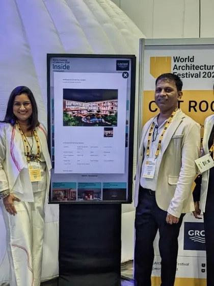 Our team standing by the digital display of our shortlisted project at WAF.
