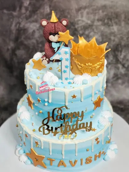 I loved creating this two-tier cake for a little one's first birthday. It features a cute, handcrafted teddy bear topper, a golden crown, and a gentle white chocolate drip over a dreamy blue frosting, making it perfect for a prince's celebration.