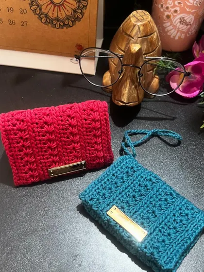 Two of my no-coin wallets, one in pink and one in blue. The blue one has a wrist strap, which is a customization I can add for you.