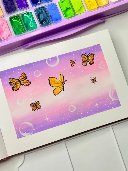 A beautiful butterfly painting with a dreamy purple and pink sky, created with gouache paints.