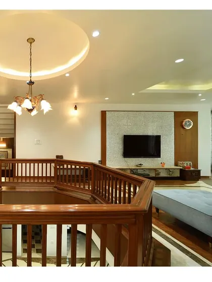 The double-height living space with a wooden railing, creating a visual connection between floors.