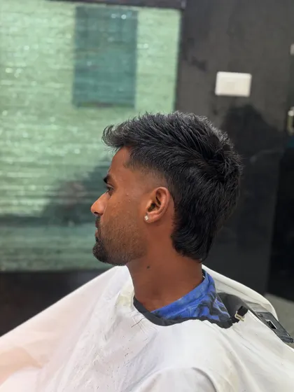 A side view of Manav Suthar's modern mullet, showing the clean fade and textured length.