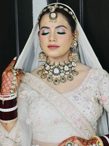 This shot highlights the flawless base and the way the makeup complements the heavy jewelry.
