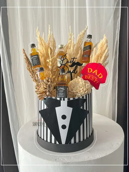 For the dad who enjoys a good drink. This Father's Day bouquet box is styled like a tuxedo and filled with dried florals and his favorite miniature liquor bottles.