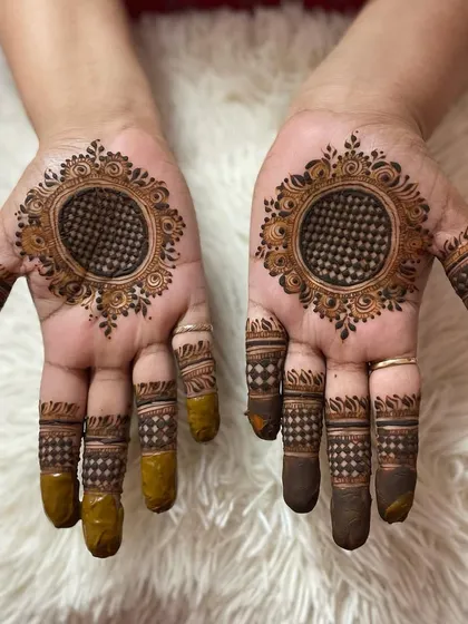 A classic mandala with a checkerboard center. The finger details match the pattern, creating a very cohesive and clean design.
