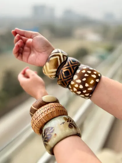 The bangle stacks against a city backdrop. It shows how you can bring a bohemian vibe to an urban setting.