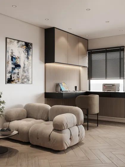 A look at the seating and workspace area in the studio apartment, demonstrating a smart use of space with a comfortable sofa and a built-in desk.
