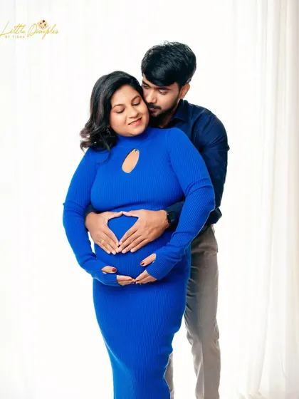 A heart for the baby. This sweet gesture from the dad-to-be makes for an adorable and loving couple's portrait.