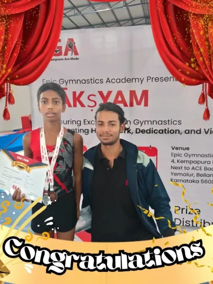 A gymnast and his coach share a proud moment after a competition. Our coaches are mentors who guide our athletes through every step of their competitive journey.