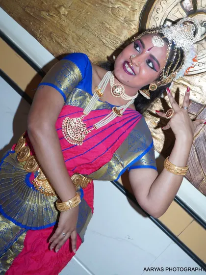 An angled shot that adds a dynamic feel to the portrait, capturing the dancer's expressive face and hand gestures.