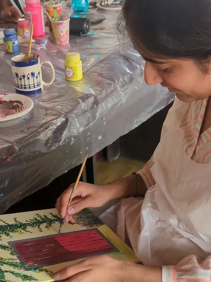 A participant adding details to her rustic door painting. It's all about taking your time and enjoying the creative journey.