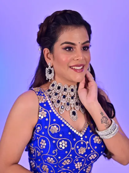 A close-up of a vibrant reception look. I used a deep blue on the eyes to match the lehenga, paired with a flawless base and a warm pink lip, creating a balanced and glamorous style perfect for an evening celebration.