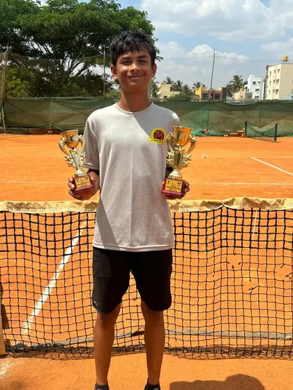Another proud shot of Svar with his singles and doubles trophies.