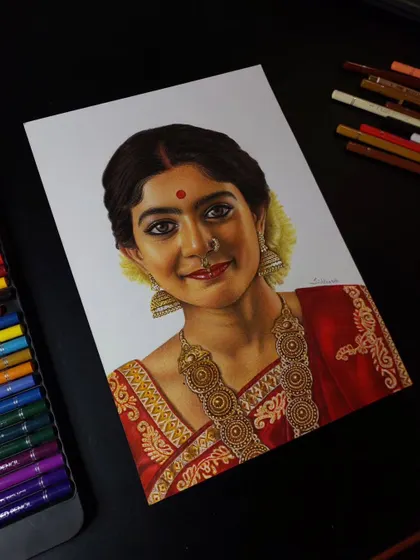 A finished portrait of the talented actress Sai Pallavi. I used Brustro colour pencils to capture her traditional look, especially the details in her jewellery and the texture of her saree.