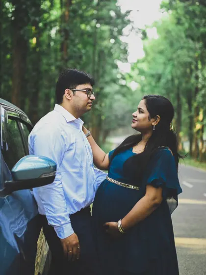 A candid moment on a quiet road, with the forest in the background. This shot captures the couple's connection and excitement during their maternity journey.