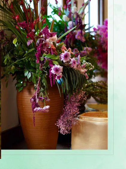 A lush floral arrangement in a large terracotta pot, featuring a cascade of purple and pink flowers. This piece added a touch of drama and color to the serene theme.