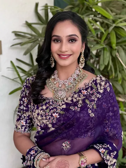 A portrait capturing the joy and elegance of this reception look. The makeup is fresh, with a pop of color on the lips.