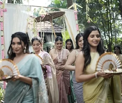 The bride's procession is a beautiful part of a Kerala wedding. Here, the bride's makeup is soft and elegant, allowing her to be the serene focus amidst her bridesmaids. This shows how I coordinate looks for the entire bridal party.